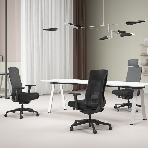 Lifestlye View of Ergonomic office chair with black mesh backrest, black frame, and cushioned seat around a boardroom table