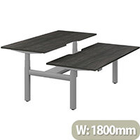 LEAP Electric Height Adjustable Sit Stand 2 Person Back To Back Bench Desk Dual Purpose Reversible Scallop Top W1800xD800(x2)xH620-1270mm Harbour Oak Top Silver Frame. Prevents & Reduces Muscle & Back Problems, Heart Risks & Increases Brain Activity.